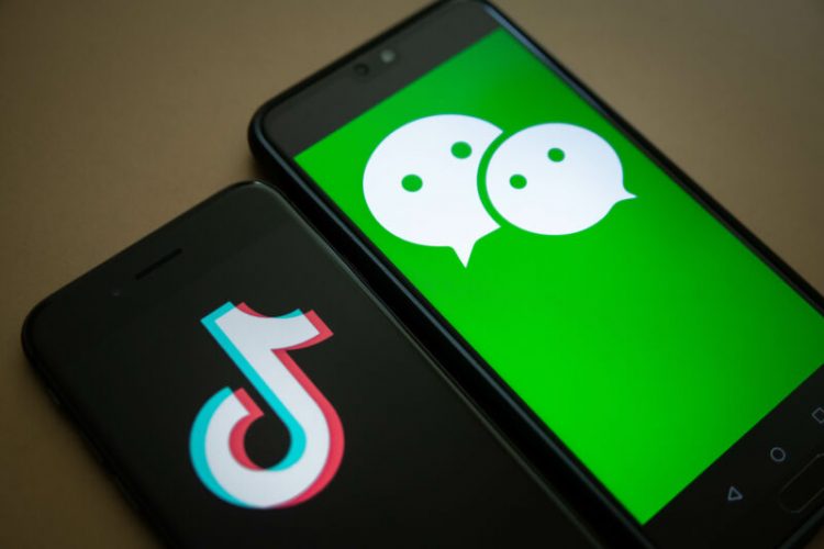 The logo for Tencent Holdings Ltd.'s WeChat app, right, and the logo for ByteDance?Ltd.'s TikTok app are arranged for a photograph on smartphones in Hong Kong, China, on Friday, Aug. 7, 2020. President Donald Trump?signed a pair of executive orders prohibiting U.S. residents from doing business with the Chinese-owned TikTok and WeChat apps beginning 45 days from now, citing the national security risk of leaving Americans' personal data exposed. Photographer: Ivan Abreu/Bloomberg via Getty Images