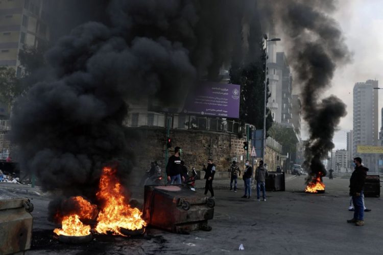 Protesters burn tires to block a road, during a protest in Beirut, Lebanon, Thursday, March 4, 2021. Lebanon has been hit by one crisis after another, with widespread protests against the country?s corrupt political class breaking out in October 2019. (AP Photo/Bilal Hussein)