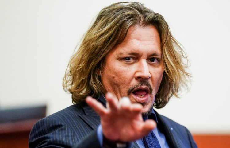 Actor Johnny Depp sits in the courtroom during his defamation case against ex-wife Amber Heard at the Fairfax County Circuit Court in Fairfax, Virginia, U.S., April 14, 2022. Shawn Thew/Pool via REUTERS