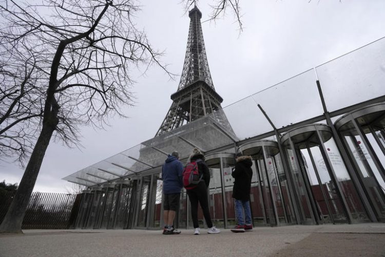 Visitors stand at the closed gates leading to the Eiffel Tower, Tuesday, Feb. 20, 2024 in Paris. Visitors to the Eiffel Tower were turned away for the second consecutive day