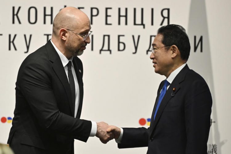 Ukraine's Prime Minister Denys Shmyhal shakes hands with Japanese Prime Minister Fumio Kishida during the Japan-Ukraine Conference for Promotion of Economic Growth and Reconstruction at Keidanren Kaikan building in Tokyo,