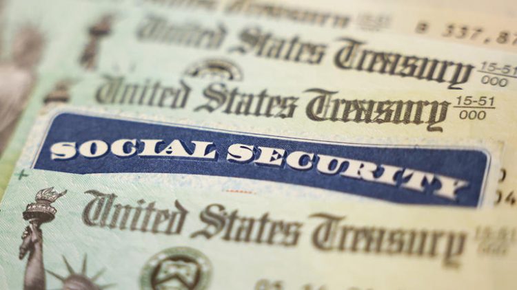 A Social Security card sits alongside checks from the U.S. Treasury. ((Photo illustration by Kevin Dietsch/Getty Images))
© (Photo illustration by Kevin Dietsch/Getty Images)