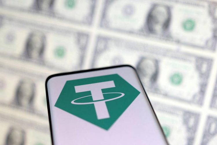 Smartphone with Tether logo is placed on displayed U.S. dollars in this illustration taken, May 12, 2022. REUTERS/Dado Ruvic/Illustration/File Photo
© Thomson Reuters