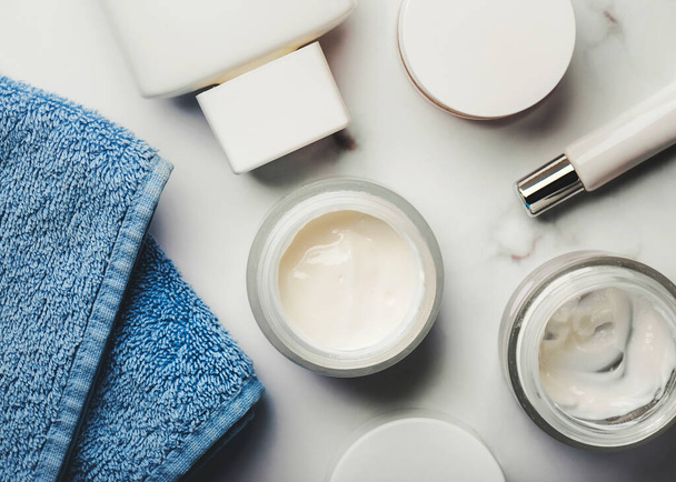 stock photo skincare products cream jars lotion exfoliating cream blue towel marble