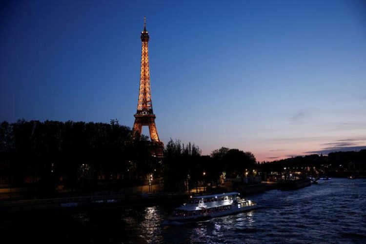 A tourist boat travels on the River Seine near the Alma bridge with the Eiffel Tower in the background at night in Paris, France, April 18, 2024. REUTERS/Benoit Tessier