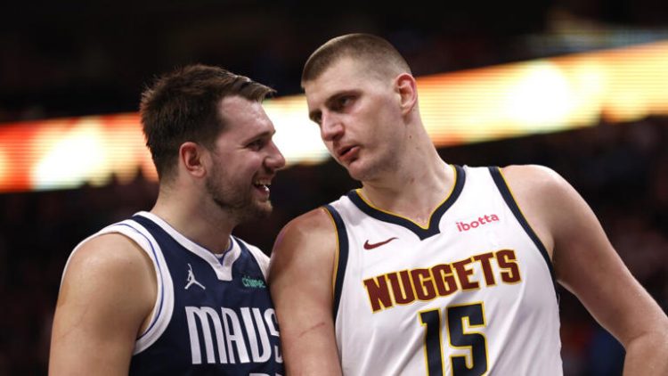 DALLAS, TX - MARCH 17: Luka Doncic #77 of the Dallas Mavericks and Nikola Jokic #15 of the Denver Nuggets talk during a beak in the action in the second half at American Airlines Center on March 17, 2024 in Dallas, Texas. NOTE TO USER: User expressly acknowledges and agrees that, by downloading and or using this photograph, User is consenting to the terms and conditions of the Getty Images License Agreement. (Photo by Ron Jenkins/Getty Images)