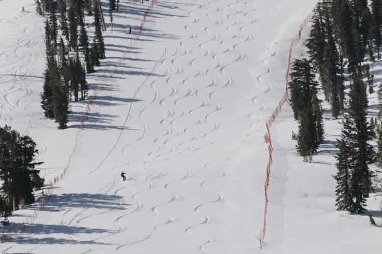 In this photo provided by Mammoth Mountain Ski Area, a snowboarder rides in Mammoth Lakes, Calif., Sunday, May 5, 2024. A weekend spring storm that drenched the San Francisco Bay area and closed Northern California mountain highways also set a single-day snowfall record for the season on Sunday in the Sierra Nevada.