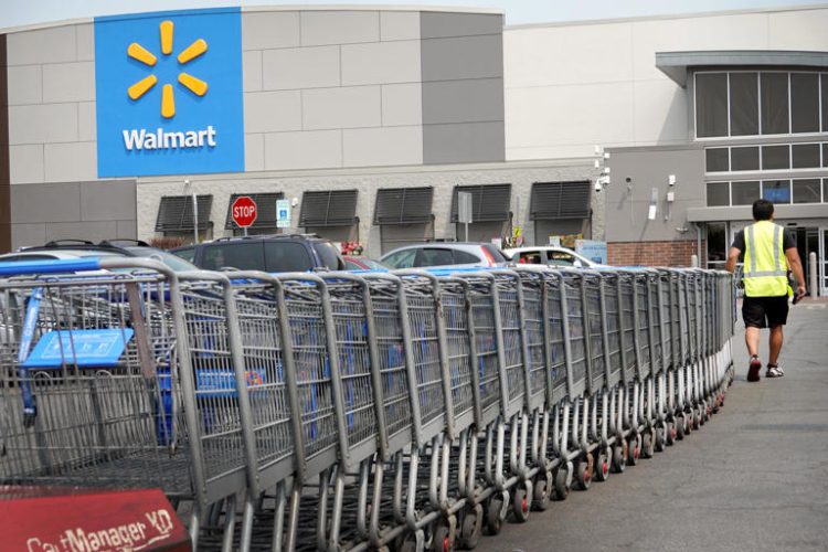 A worker collects shopping carts from the parking lot of a Walmart store in Chicago. Scott Olson/Getty Images