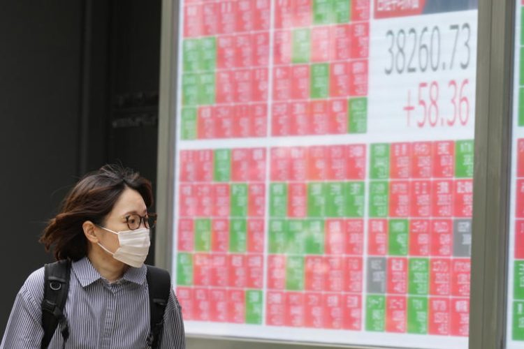 A person looks at an electronic stock board showing Japan's Nikkei 225 index at a securities firm Thursday, May 9, 2024, in Tokyo.