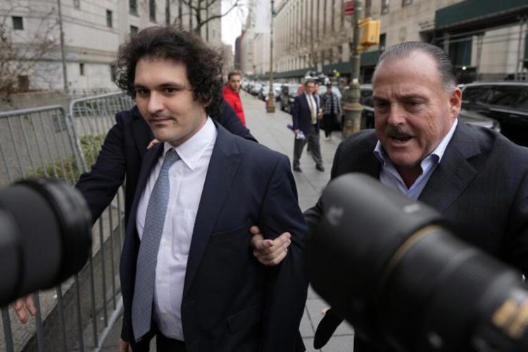 FTX founder Sam Bankman-Fried, left, arrives at Manhattan federal court, Thursday, Feb.16, 2023, in New York.