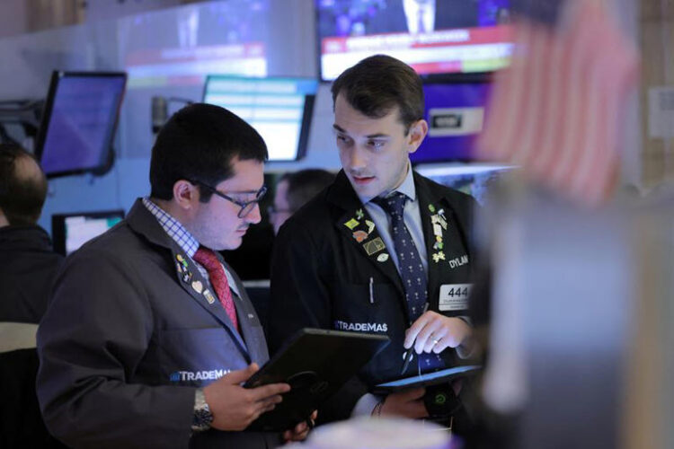 Traders work on the trading floor at the New York Stock Exchange (NYSE) in New York City, U.S., April 5, 2024. REUTERS/Andrew Kelly