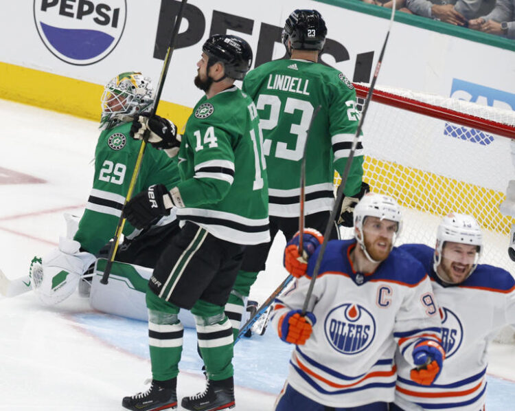 Dallas Stars goaltender Jake Oettinger looks away as Edmonton Oilers center Connor McDavid (second from right) celebrates with teammate Mattias Janmark (13) after McDavid scored in in the second overtime of Game 1 of the NHL Western Conference finals Thursday at American Airlines Center.
© Chitose Suzuki/The Dallas Morning News/TNS