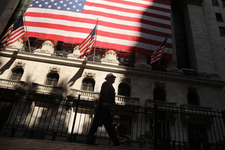 A man strolls past the New York Stock Exchange. Getty Images