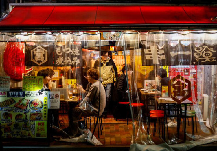 People enjoy drinks and food at an izakaya pub restaurant at the Ameyoko shopping district, in Tokyo, Japan February 15, 2024. REUTERS/Issei Kato/File Photo