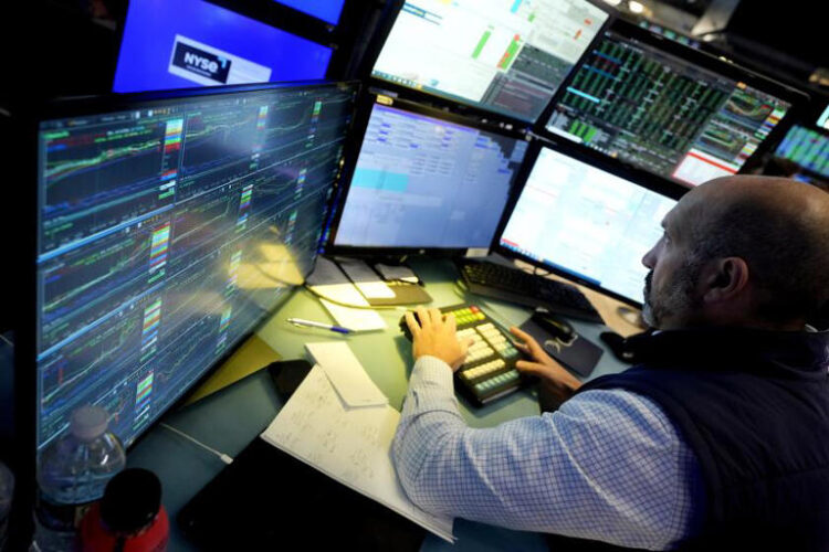 Specialist James Denaro works at his post on the floor of the New York Stock Exchange on June 12. Global shares were mixed Friday after Wall Street touched fresh records, with benchmarks pushed higher by the frenzy over artificial-intelligence technology. ((Richard Drew / Associated Press))
