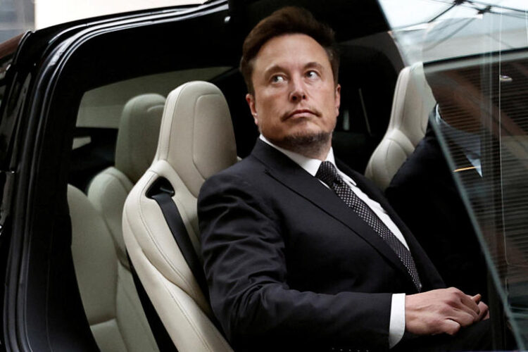 Tesla CEO Elon Musk gets in a Tesla car as he leaves a hotel in Beijing, China May 31, 2023. (REUTERS/Tingshu Wang/File Photo)