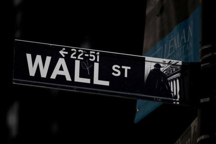 A Wall St. street sign is seen near the New York Stock Exchange (NYSE) in New York City, U.S., September 17, 2019. REUTERS/Brendan McDermid/File Photo