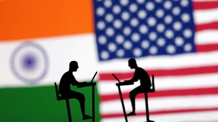 The Indian flag, the U.S. flag and people miniatures with laptops are seen in this illustration taken March 10, 2024. REUTERS/Dado Ruvic/Illustration/File Photo