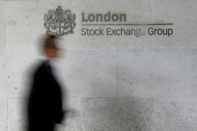 A man walks past the London Stock Exchange in the City of London October 11, 2013.REUTERS/Stefan Wermuth//File Photo