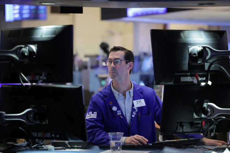 A trader works on the trading floor at the New York Stock Exchange (NYSE) in New York City, U.S., April 5, 2024. REUTERS/Andrew Kelly/File Photo