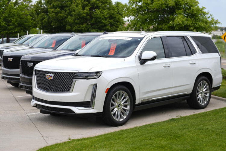 Unsold 2024 Escalade utility vehicles sit in a row outside a Cadillac dealership on June 2, 2024, in Lone Tree, Colo. General Motors reports earnings on Tuesday, July 23, 2024. (AP Photo/David Zalubowski, File