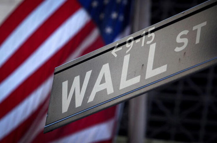 A Wall Street sign is pictured outside the New York Stock Exchange in New York, October 28, 2013. REUTERS/Carlo Allegri/File Photo/File Photo