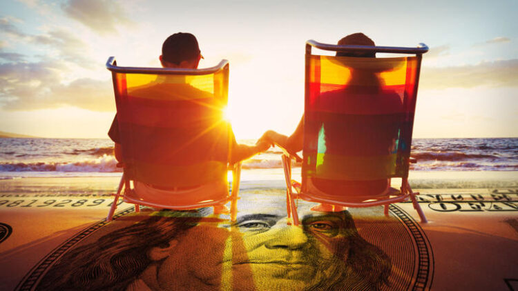 A couple is seen relaxing on a beach with a $100 bill superimposed on the sand. Dave Ramsey says it's important to invest in a Roth IRA to complement your 401(k). Shutterstock/TheStreet