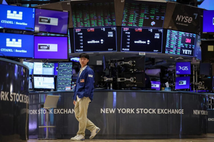 Traders work on the floor at the New York Stock Exchange (NYSE) in New York City, U.S., August 8, 2024