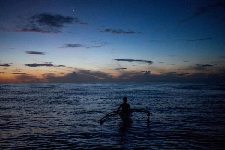 A Filipino fisheman rows a boat during a trip near the disputed Scarborough Shoal, in Masinloc, Zambales province, Philippines, July 18, 2022. REUTERS/Lisa Marie David/File Photo