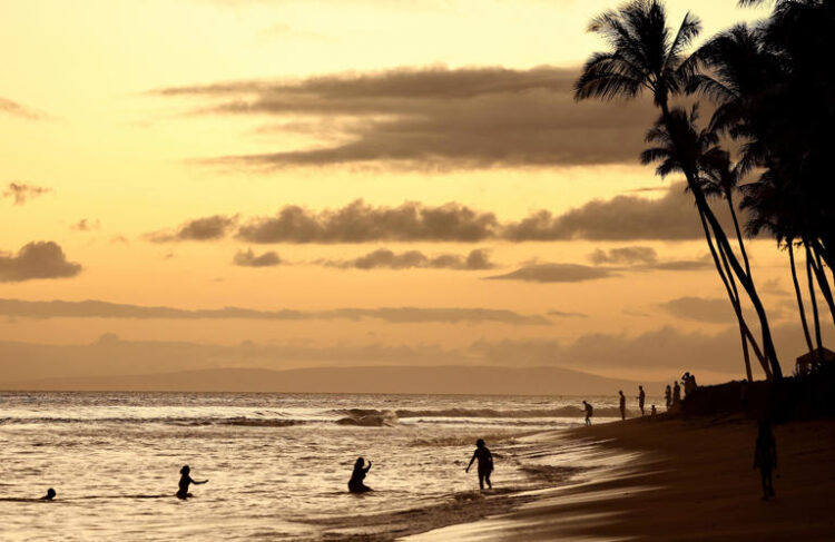 People gather on the beach on Aug. 4, 2024 in Lahaina, Hawaii.