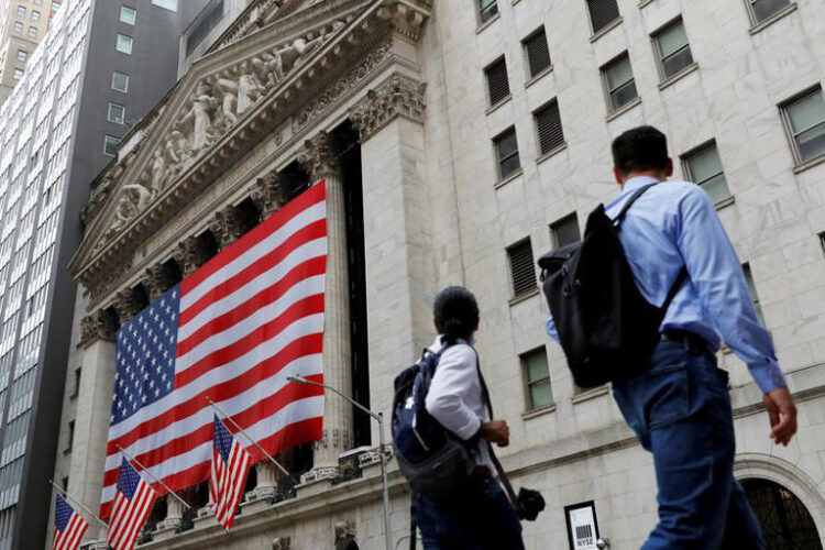 People walk by the New York Stock Exchange (NYSE) in Manhattan, New York City, U.S., August 9, 2021. REUTERS/Andrew Kelly/File Photo