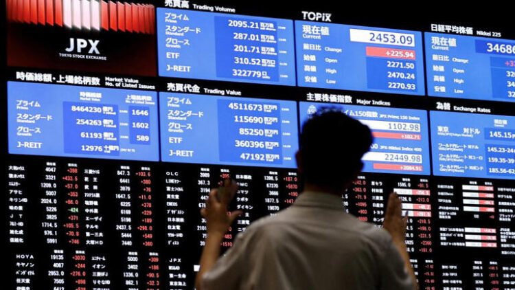 Media members observe the stock quotation board at the Tokyo Stock Exchange in Tokyo, Japan, on August 6, 2024.