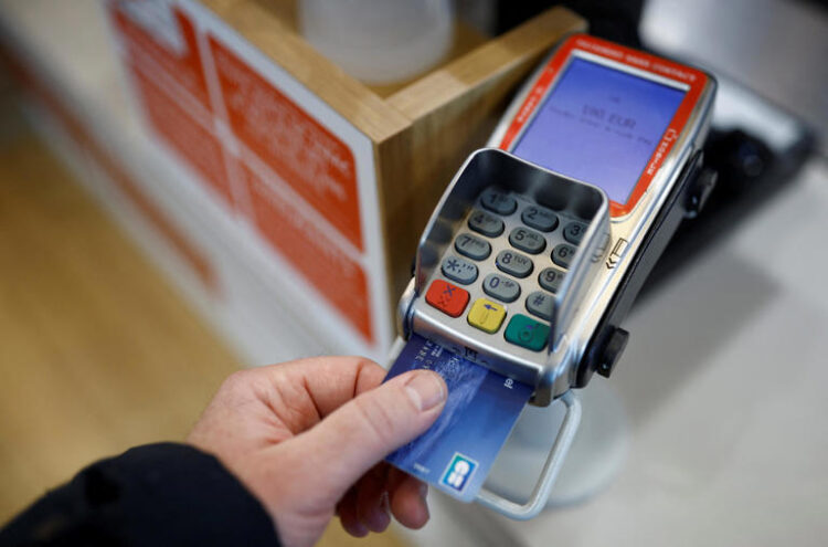 A credit card is used on a payment terminal at a shop near Nantes, France, in this illustration picture taken November 6, 2023.