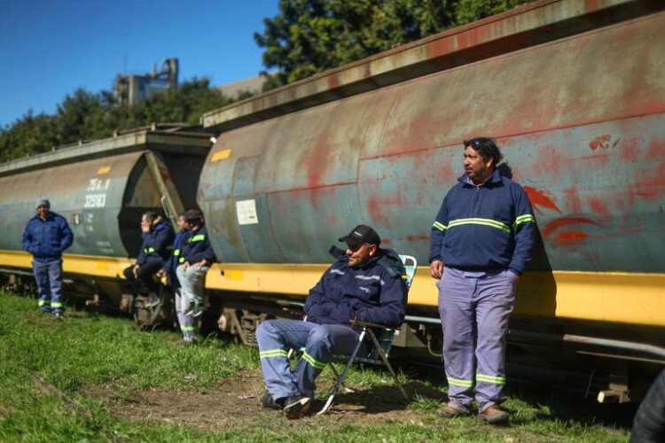 Oilseed workers stand near train wagons used to carry grains as an oilseed workers strike affects terminals, in Rosario, Argentina August 9, 2024.